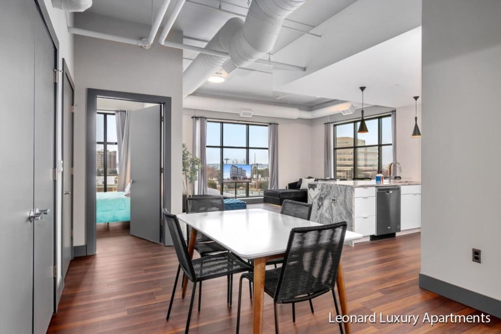 Dining area and open-plan living space at Downtown Muskegon Apartment #306