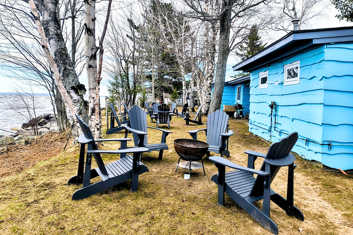 Fire pit, chairs and blue home at Paradise Lakeside Retreat