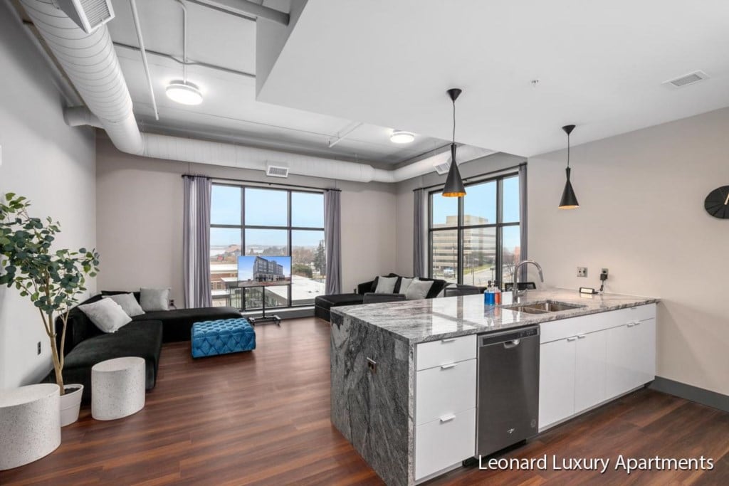 Open-plan living room and kitchen with city views at Downtown Muskegon Apartment #306