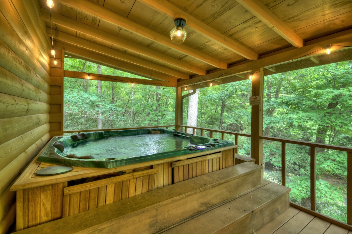 Covered outdoor hot tub at At Water's Edge cabin