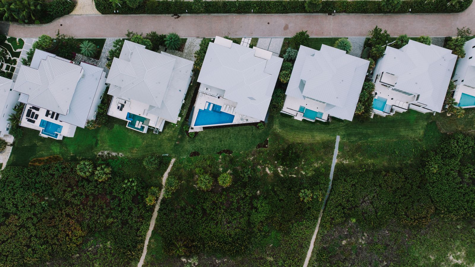 Aerial view of Florida homes with private pools in a coastal neighbourhood