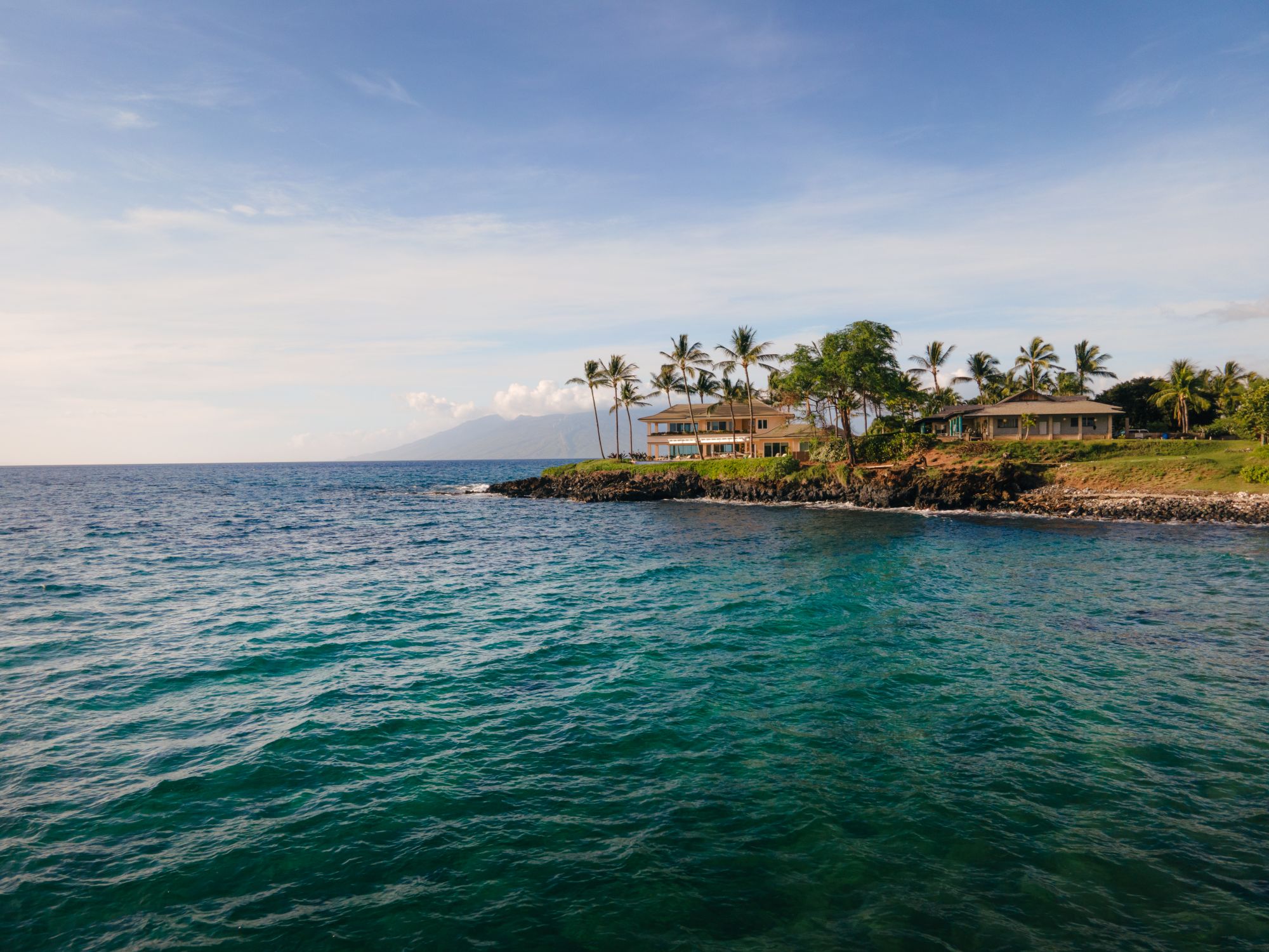 Oceanfront homes among palms on the Kihei coast of Maui