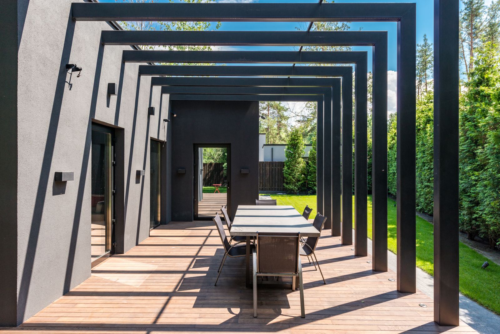 Contemporary home patio with a pergola and outdoor dining table